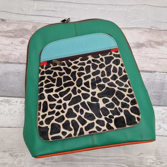 Emerald Green Leather Ruch Sack with a front panel in Giraffe Print.