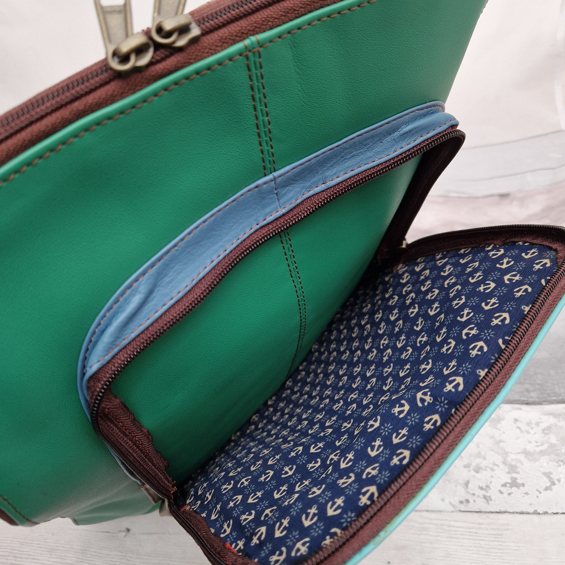 Emerald Green Leather Ruch Sack with a front panel in Giraffe Print.