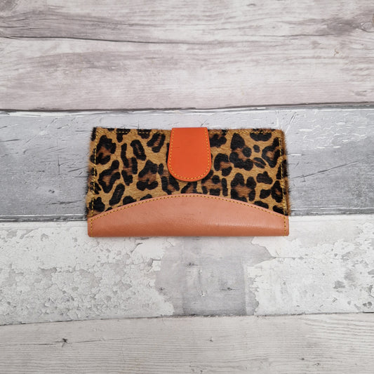 Purse made from leather off cuts featuring textured panels in a leopard print.