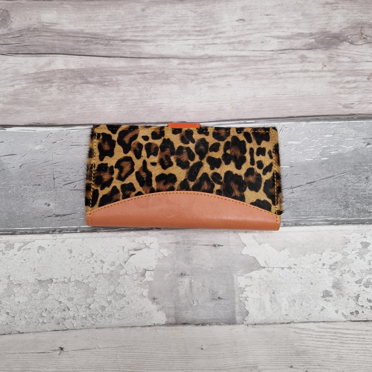Purse made from leather off cuts featuring textured panels in a leopard print.