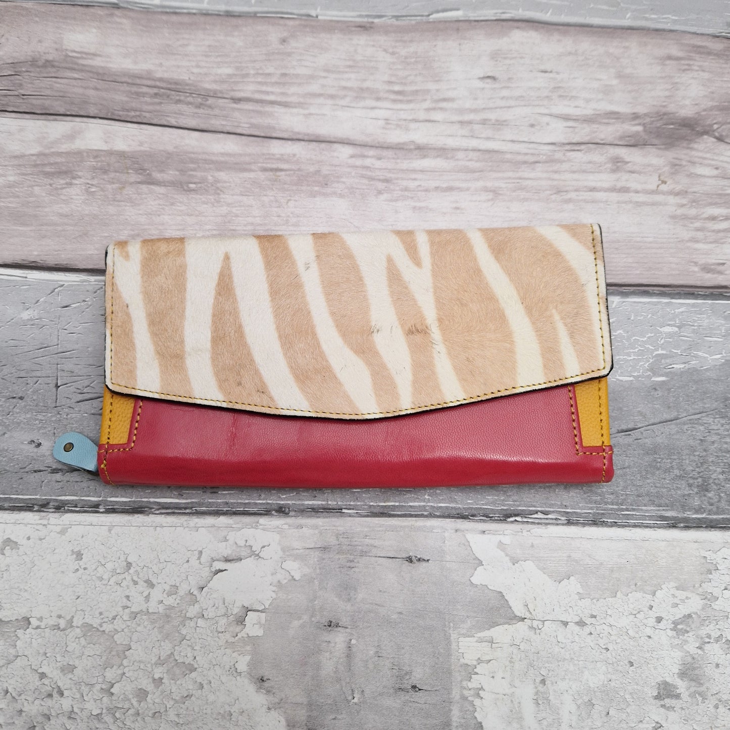 Purse made from leather off cuts featuring textured panels in a zebra print.