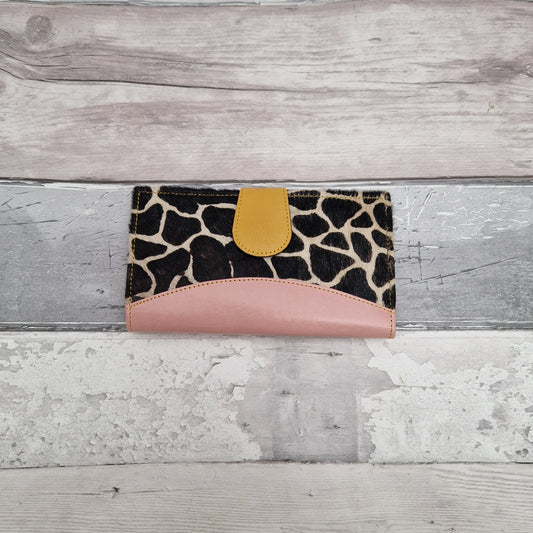 Purse made from leather off cuts featuring textured panels in a giraffe print.
