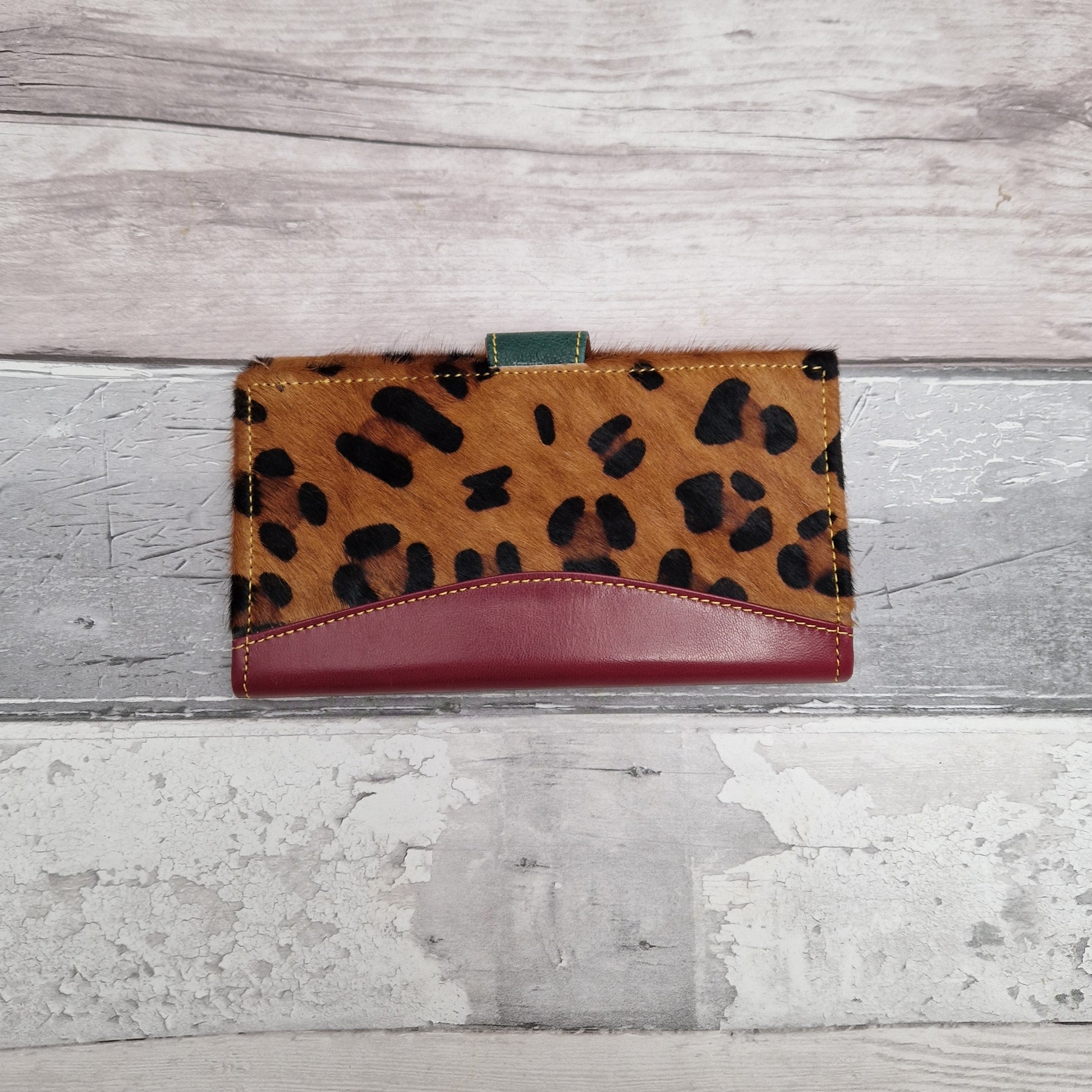 Purse made from leather off cuts featuring textured panels in a Leopard print.