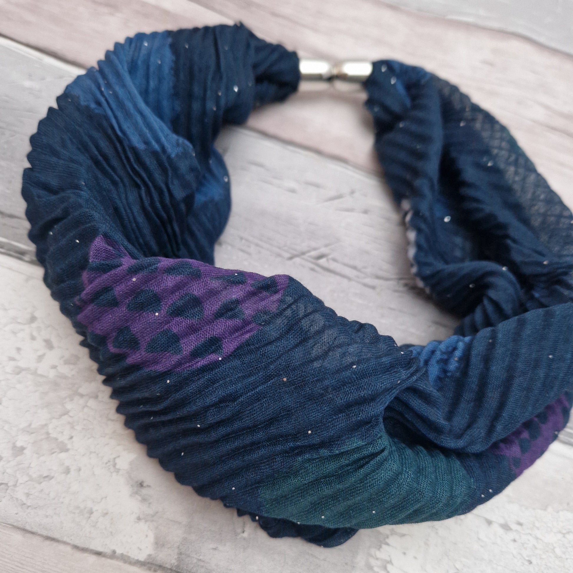 Crinkle effect magnetic neck scarf in dusky pink. Decorated with patterned circles or white, teal and purple.