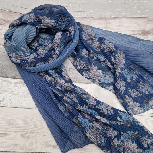 Blue toned scarf decorated with swathes of blue and climbing rose print.