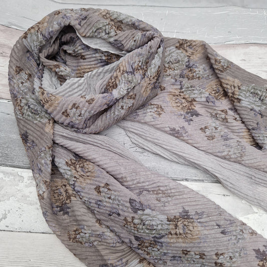 Beige toned scarf decorated with swathes of beige and climbing rose print.
