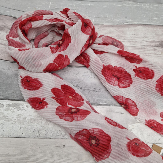 White scarf in a crinkle fabric decorated with red poppies.