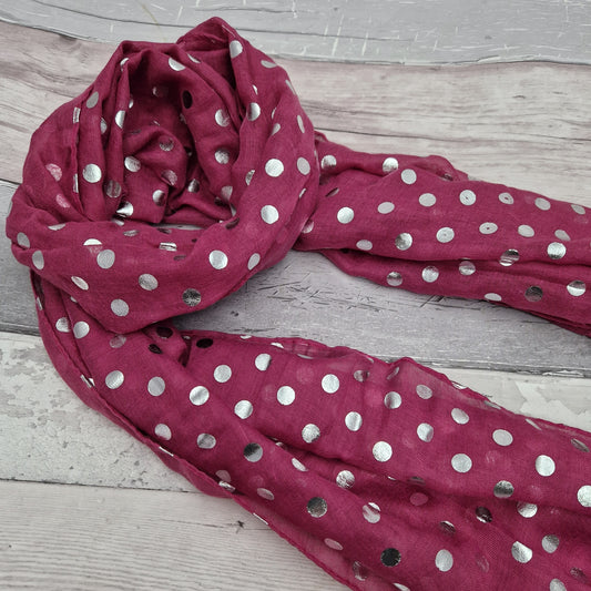 Magenta pink coloured scarf covered in metallic silver spots.
