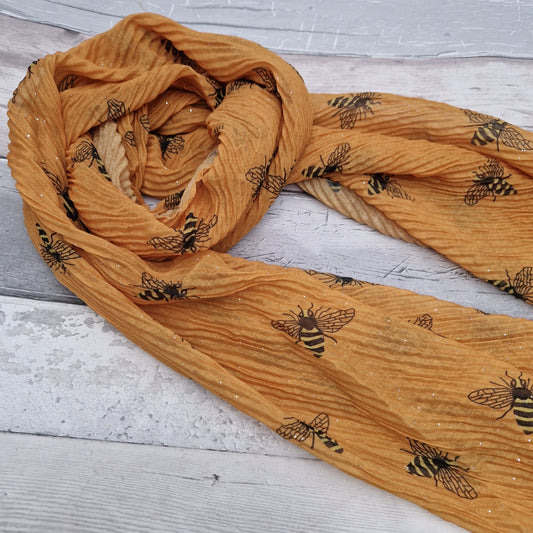 Mustard scarf in a crinkle fabric featuring black and yellow bees.