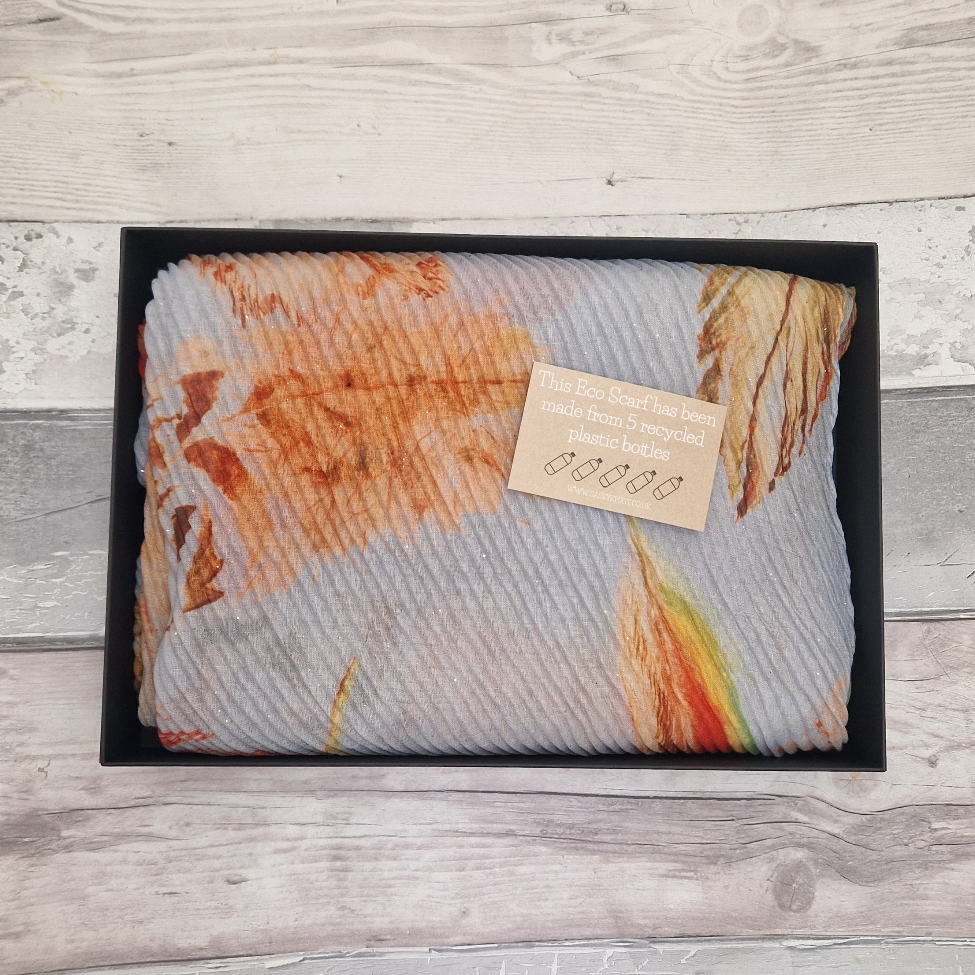 Gift Boxed Eco Scarf in Grey with Orange coloured leaves and feathers.