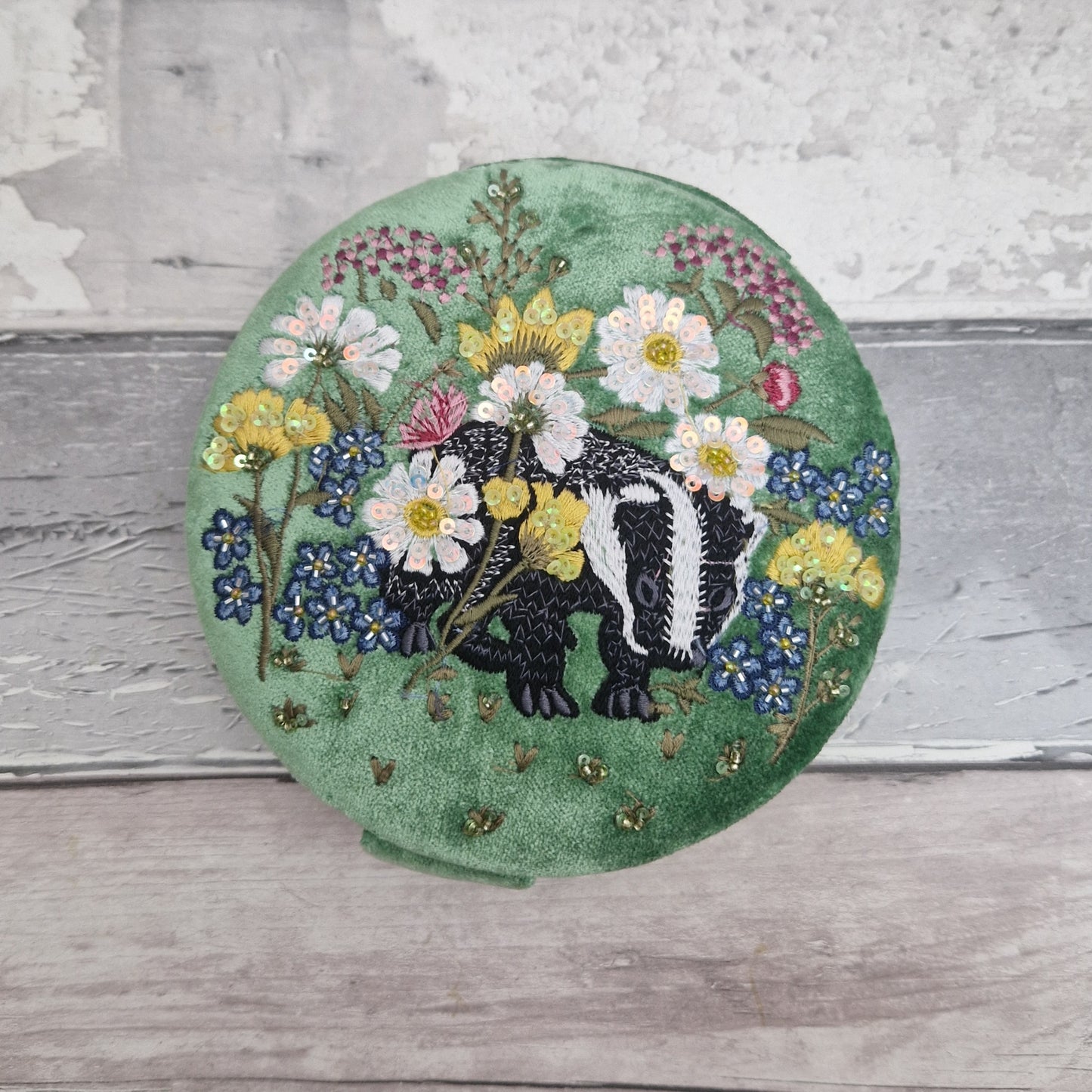 Green velvet covered jewellery box featuring an embroidered design of a Badger in a flower garden. Finished with beads and sequins.