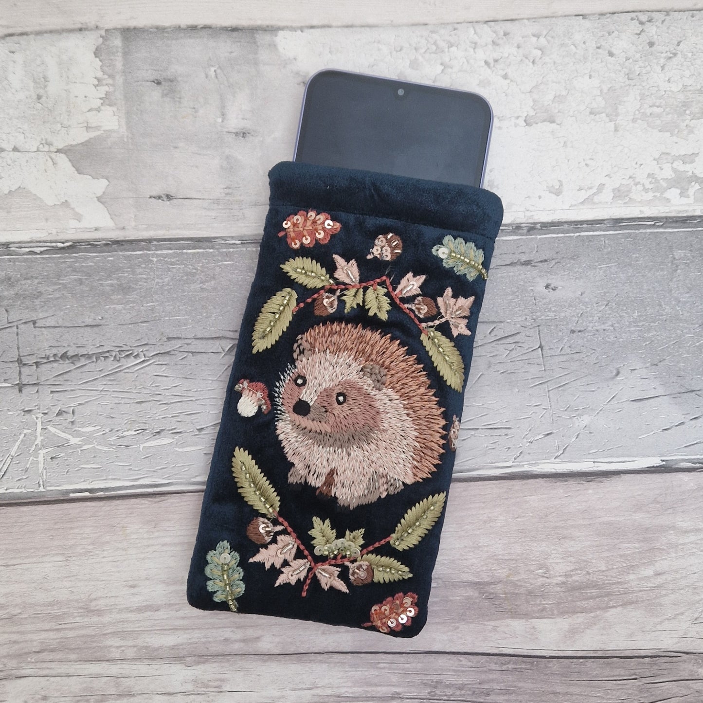 Navy velvet glasses case decorated with an embroidered Hedgehog woodland scene. Finished with beads and sequins.