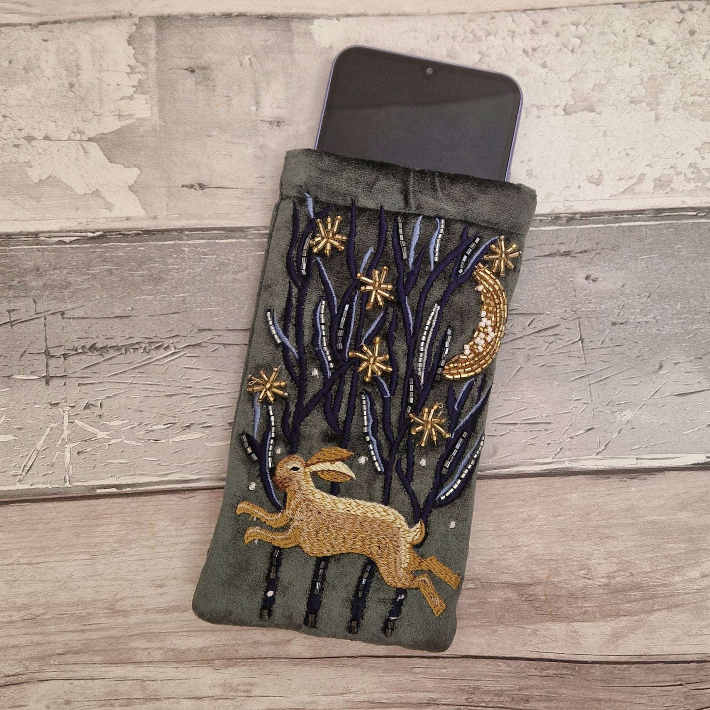 Dark grey velvet glasses case decorated with an embroidered Hare running through the woods under a crescent moon and starry night scene. Finished with beads and sequins.