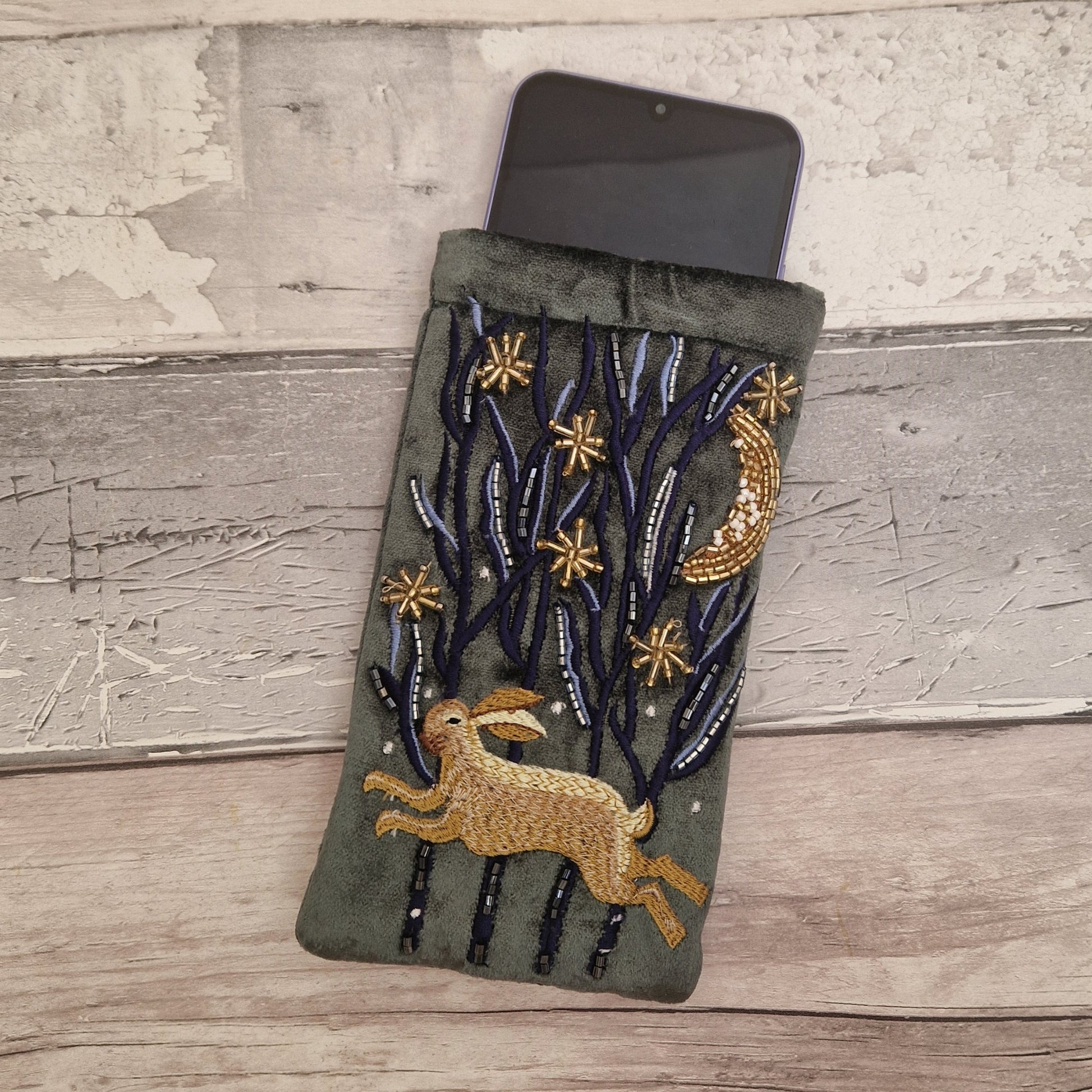 Dark grey velvet glasses case decorated with an embroidered Hare running through the woods under a crescent moon and starry night scene. Finished with beads and sequins.