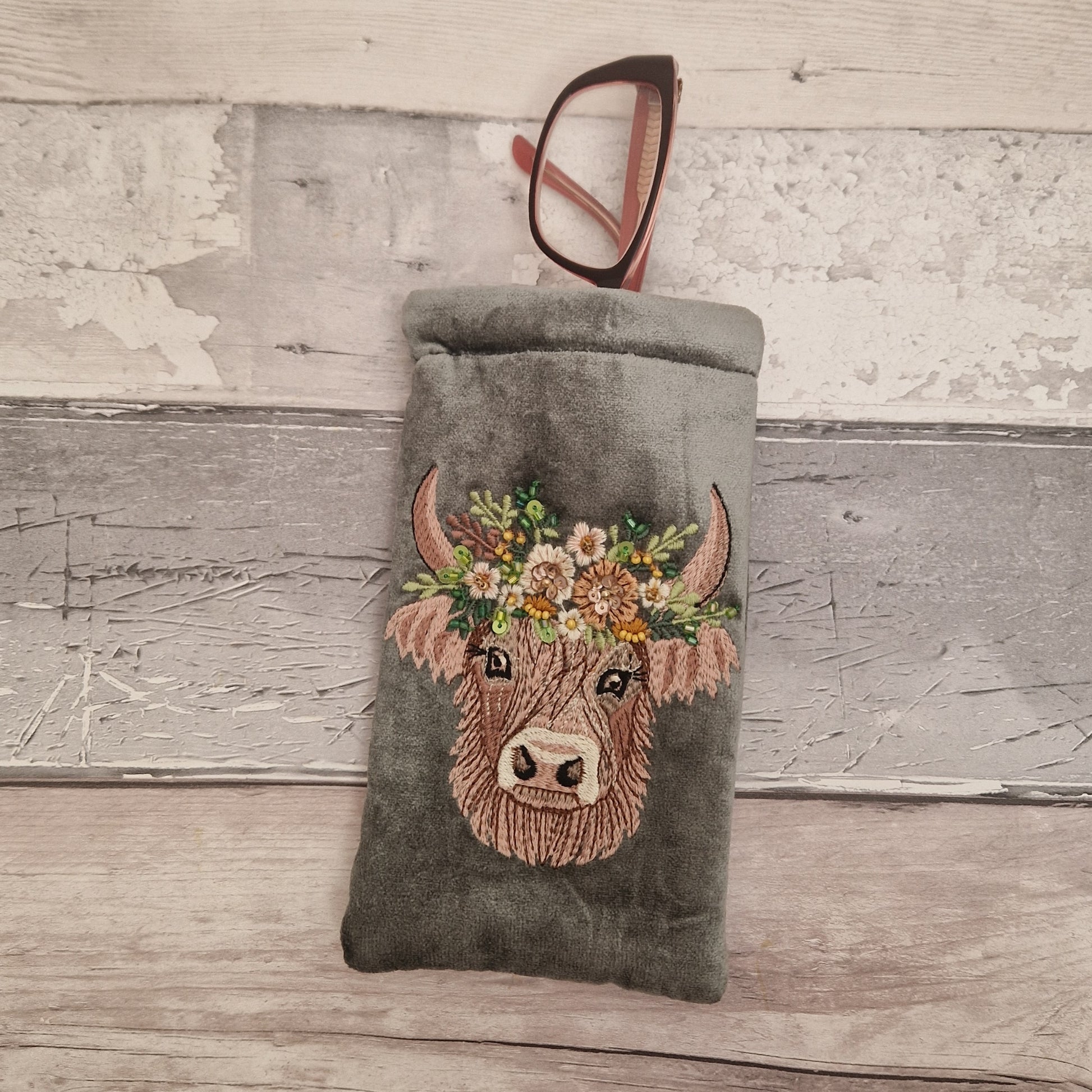 Grey velvet glasses case decorated with an embroidered Highland Cow. Finished with beads and sequins.