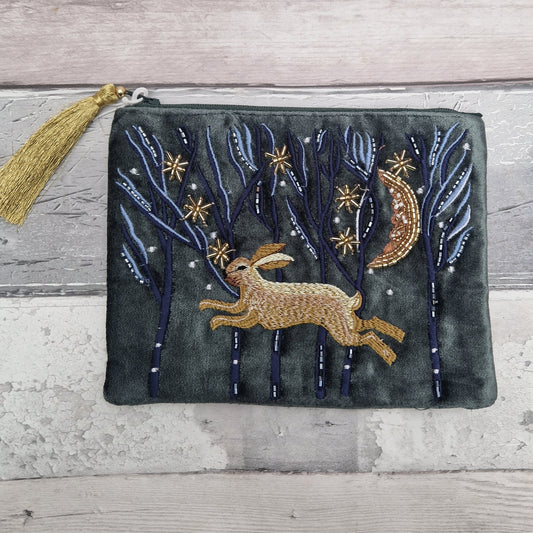 Dark grey velvet pouch with an embroidered scene featuring a graceful hare running through the forest beneath a crescent moon and a sky full of stars. Finished in metallic beads.