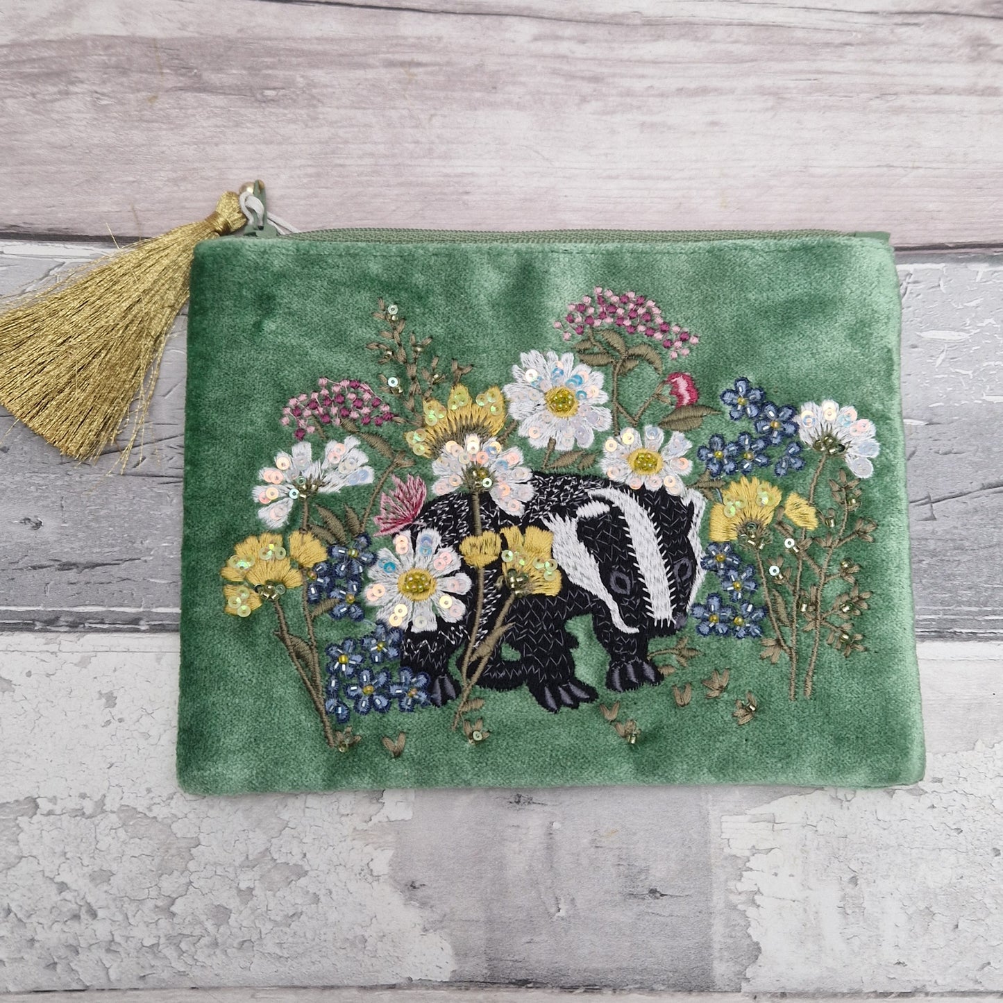 Green velvet pouch with embroidered badger and flowers finished with beads and sequins.
