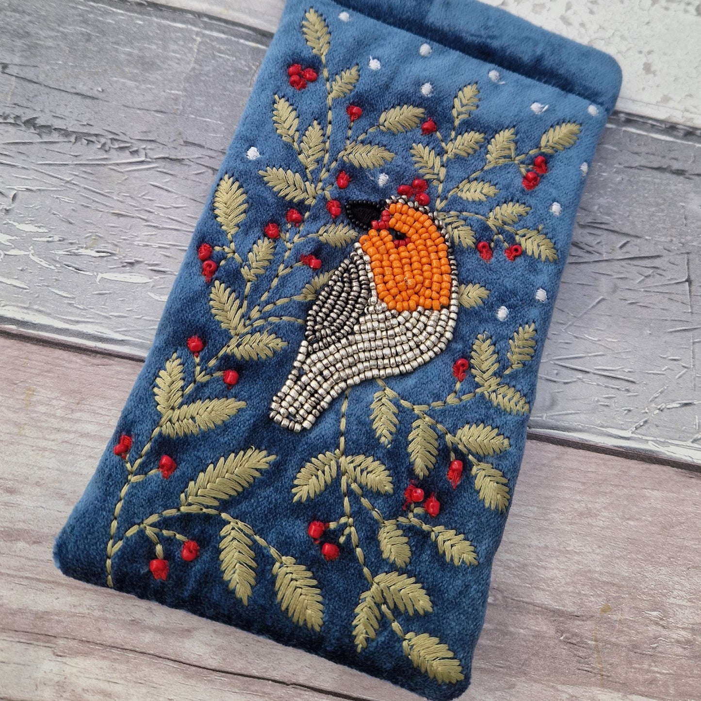 Dusky Blue Velvet Glasses Pouch decorated with an embroidery and bead design featuring a Robin surrounded by festive holly.