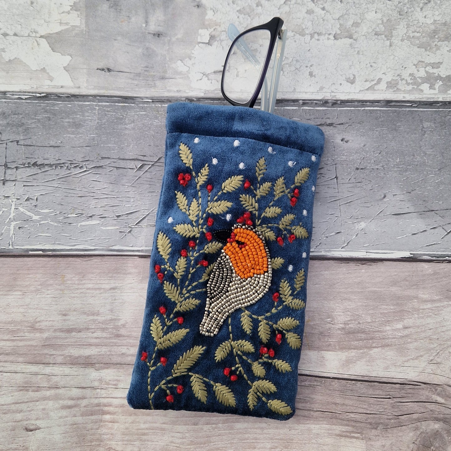Dusky Blue Velvet Glasses Pouch decorated with an embroidery and bead design featuring a Robin surrounded by festive holly.