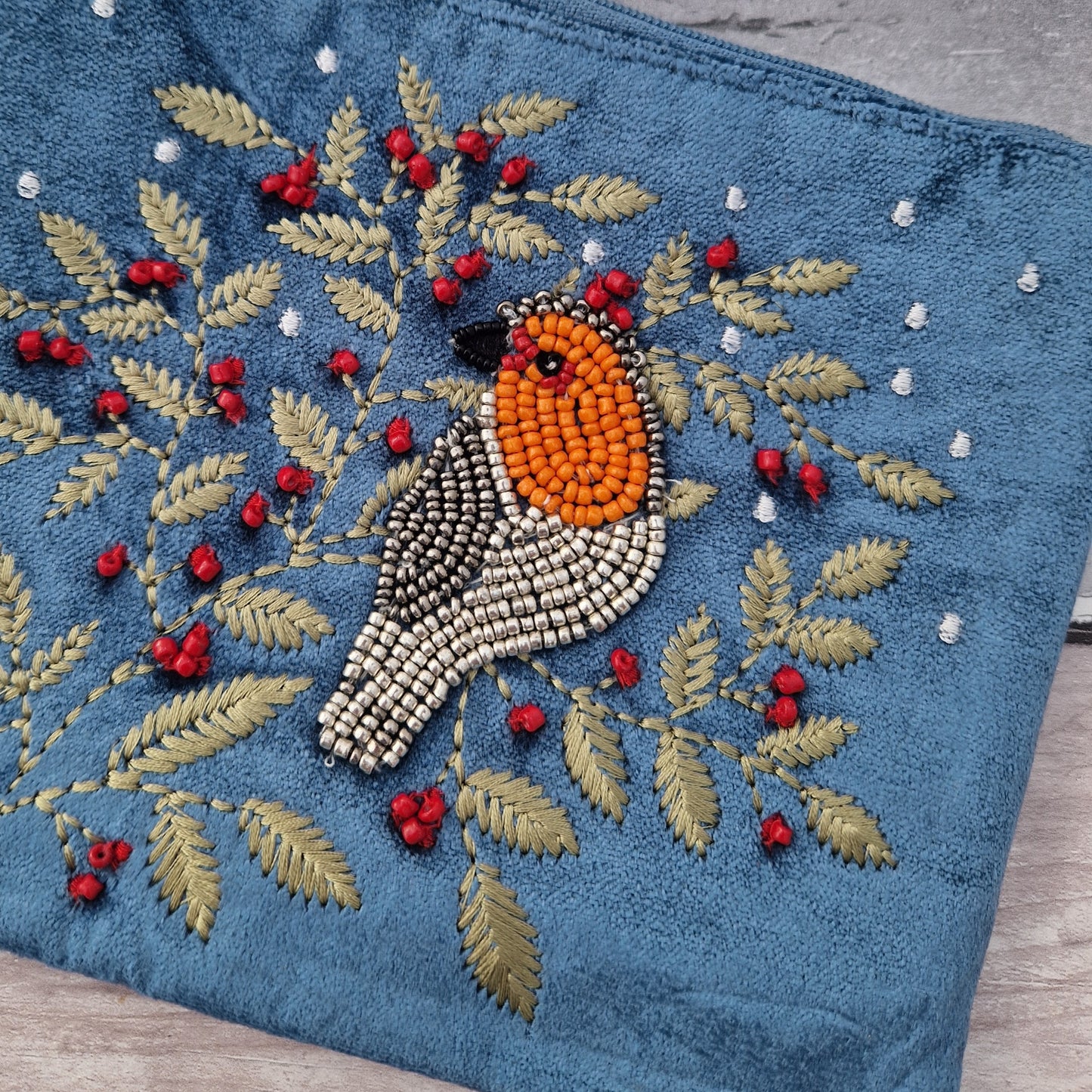 Dusky Blue Velvet Make up Bag decorated with an embroidery and bead design featuring a Robin surrounded by festive holly.