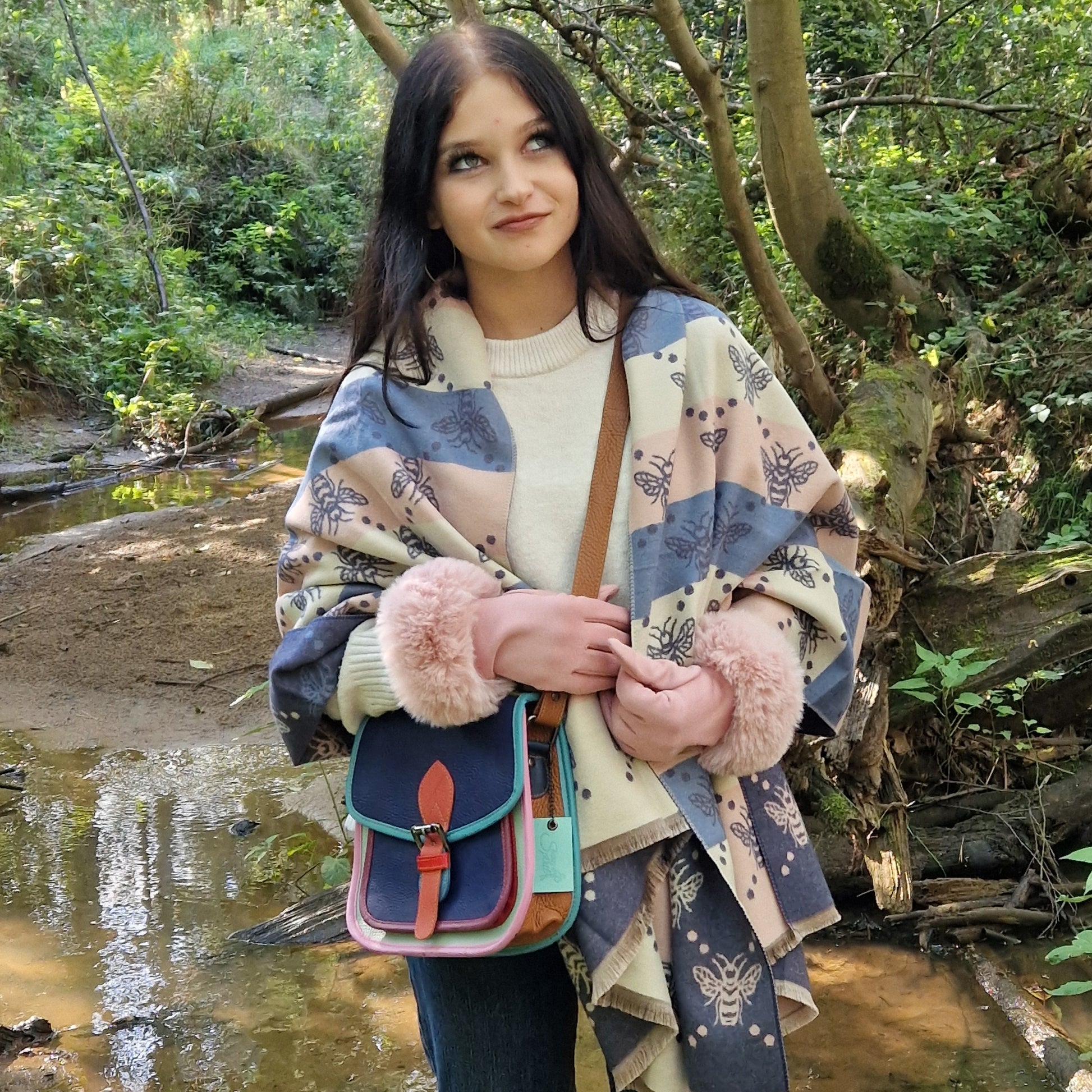 Woman holding a colorful bag in a forest setting
