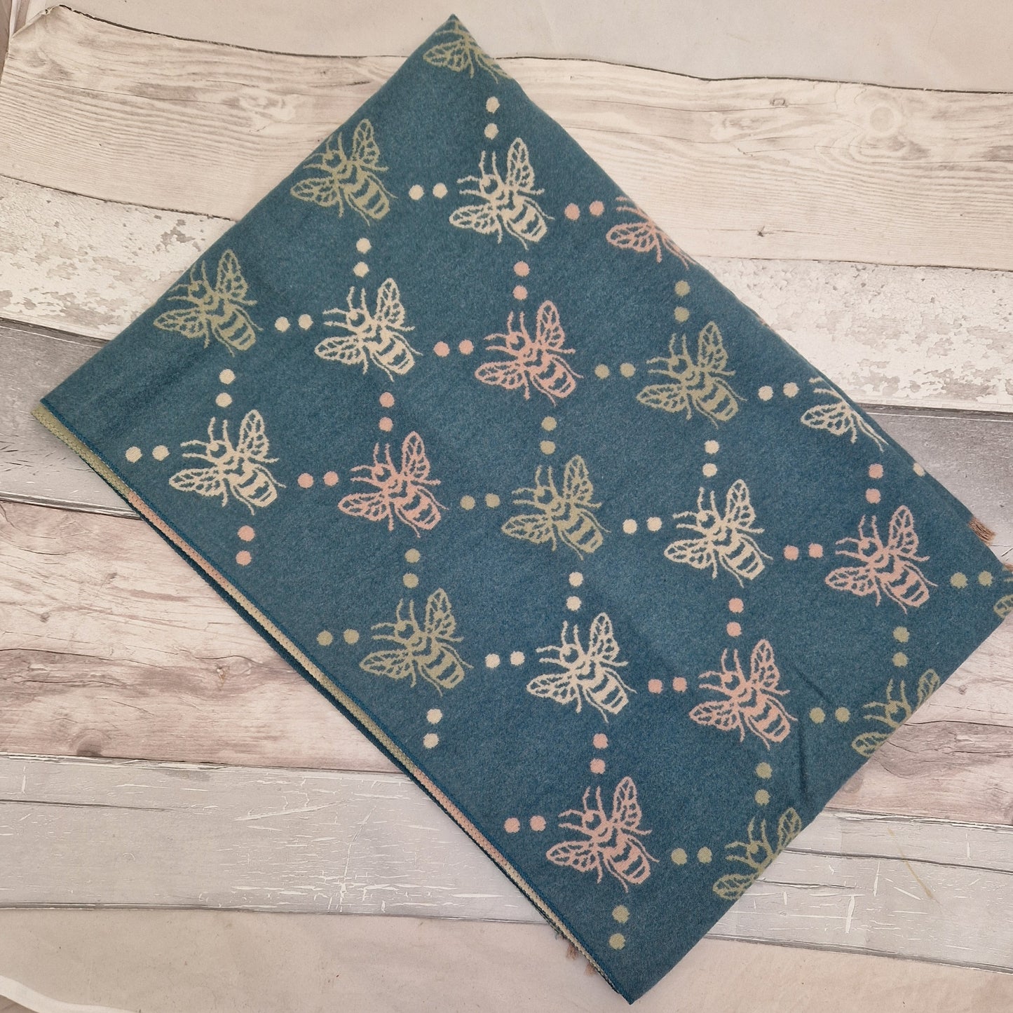 Turquoise Bee print scarf with accents of pink, olive green and cream.