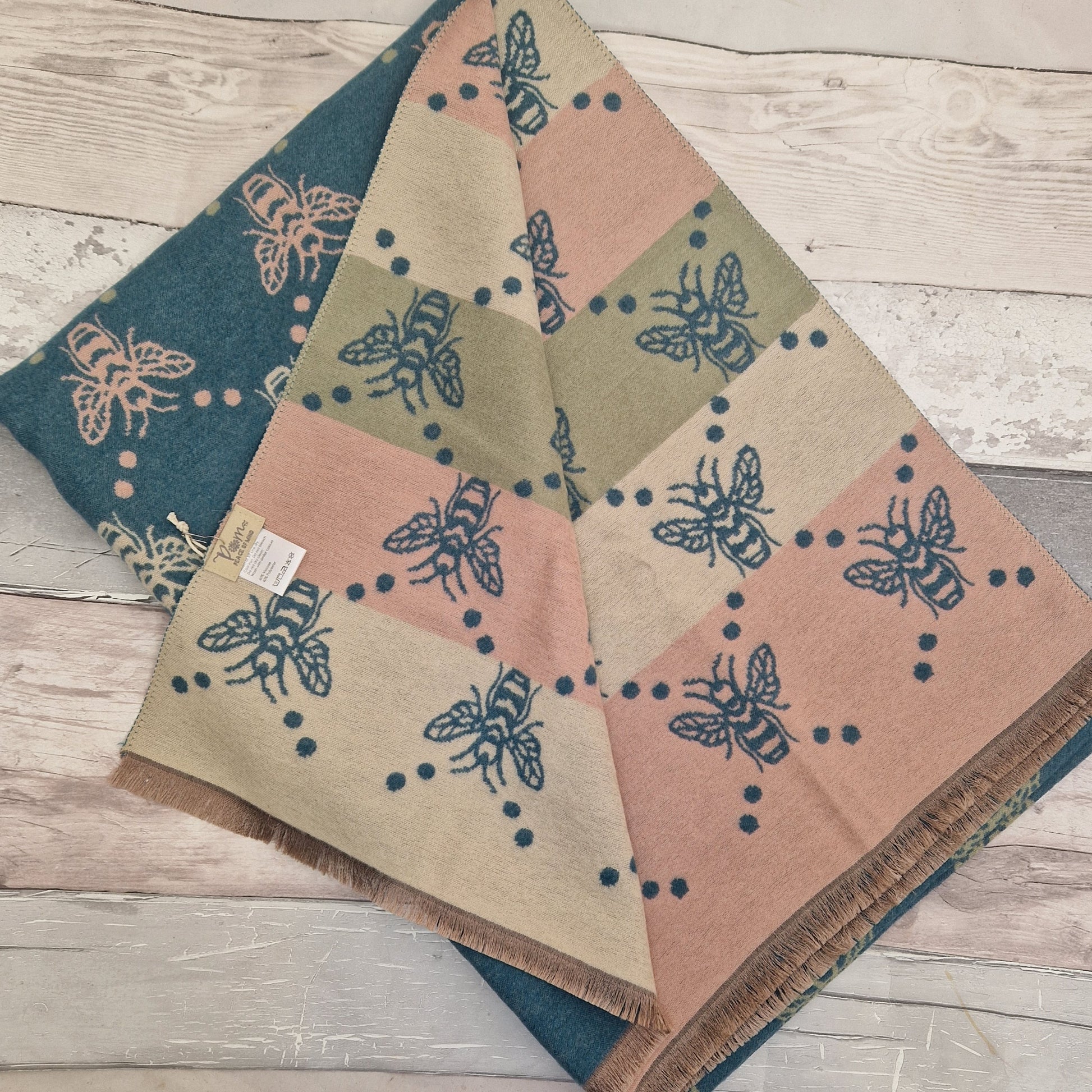 Reversible bee print scarf in a mix of turquoise, pale pink, olive green and cream.