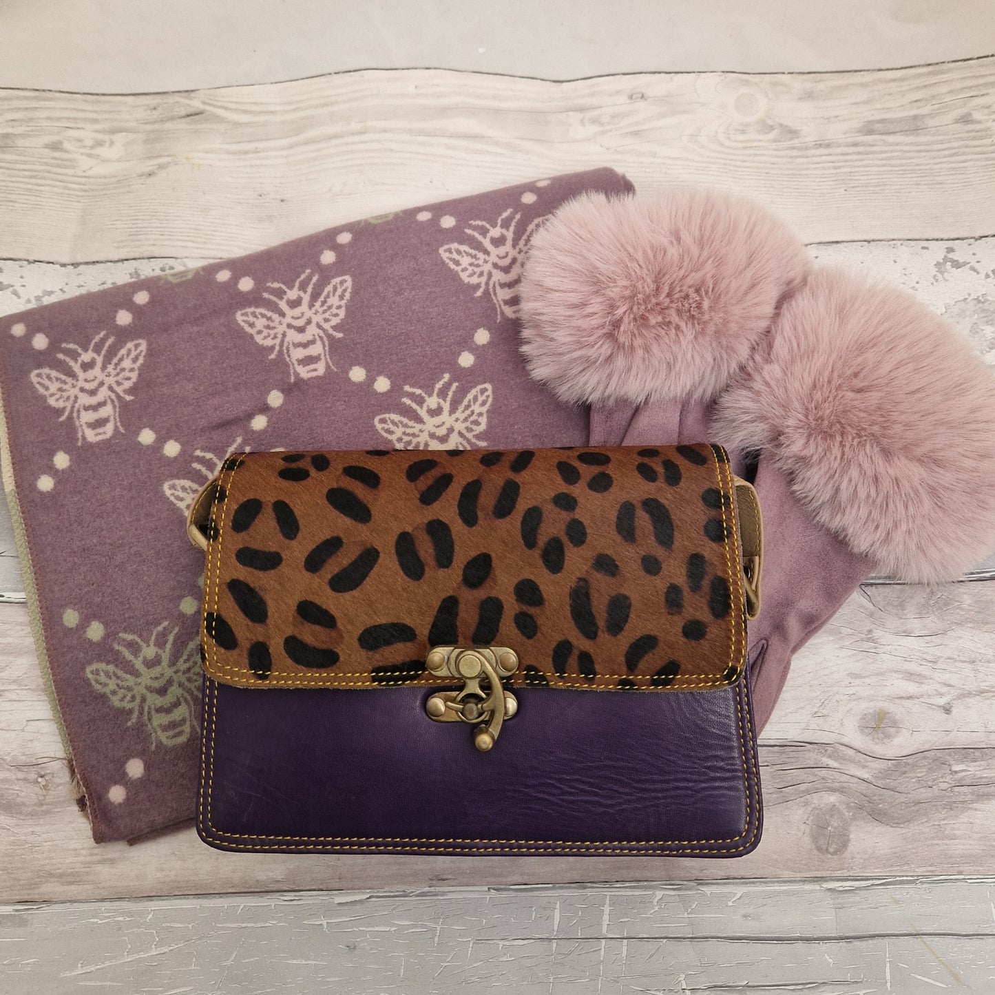 Purple accessories comprising, puple bee print scarf, lilac gloves and purple tiya bag.