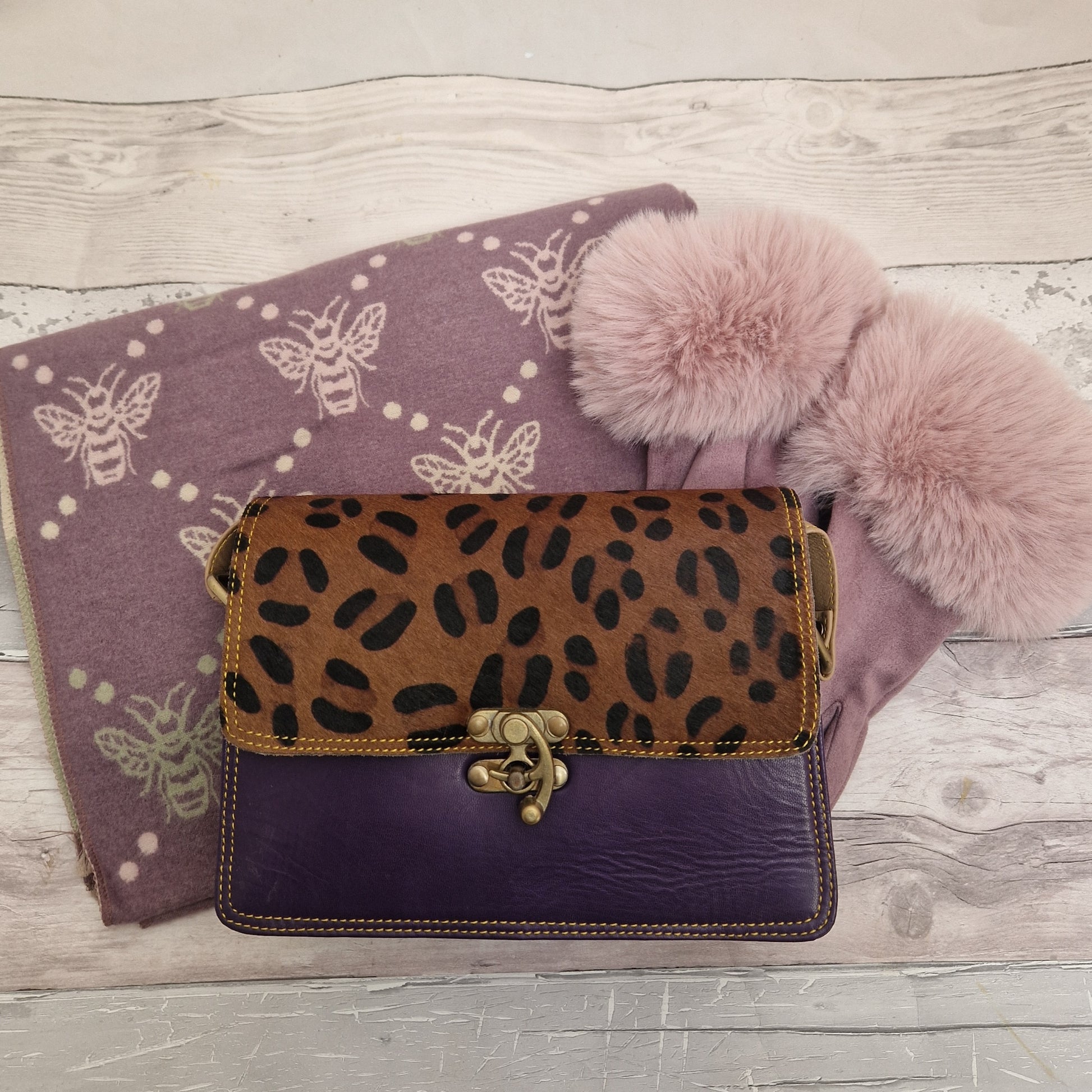 Purple accessories comprising, puple bee print scarf, lilac gloves and purple tiya bag.