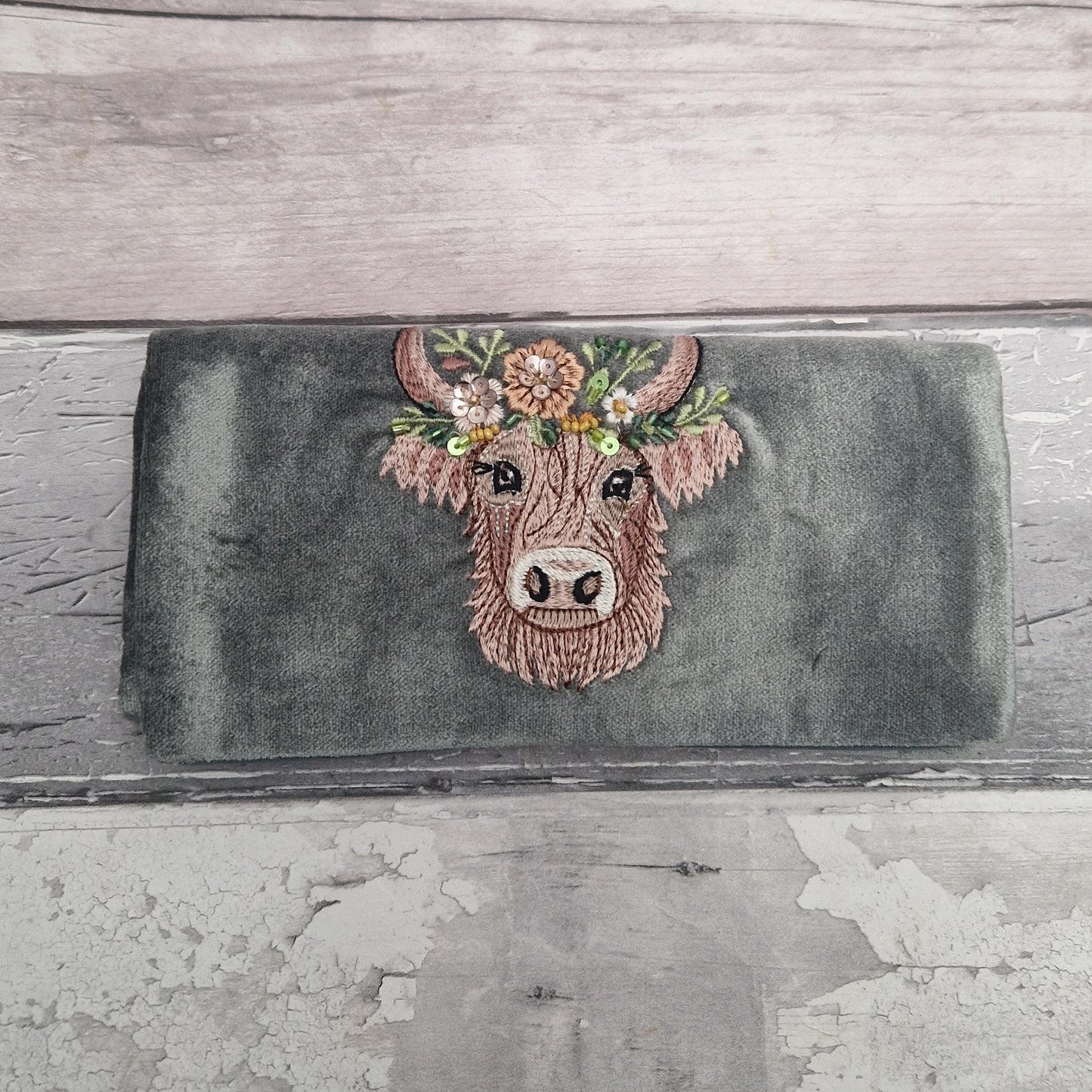 Velvet Jewellery Roll decorated with a hand embroidered image of a Highland Cow.