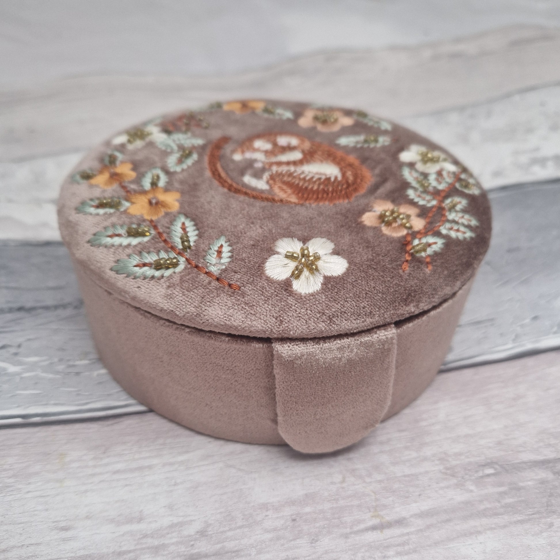 Buff Velvet Jewellery Box embroidered with a design of a dormouse asleep in amongst flowers and leaves.