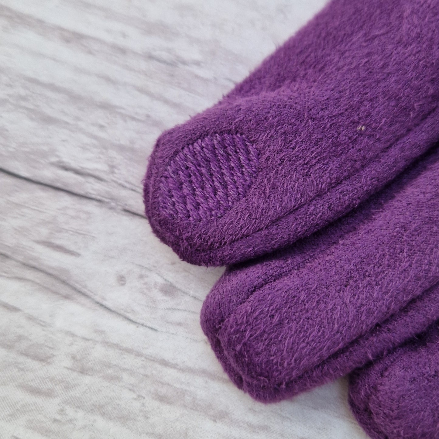 Textured pad on finger of glove.