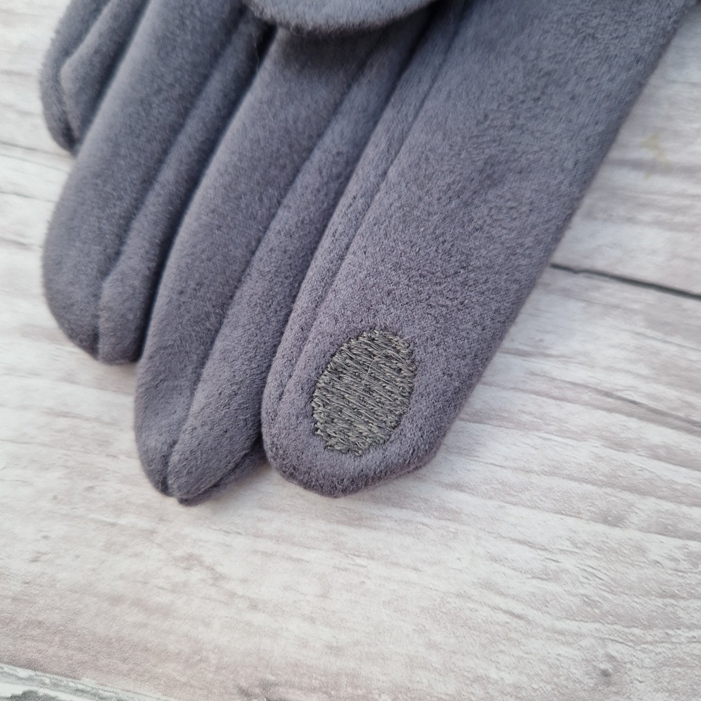 Textured finger pad on glove tip.