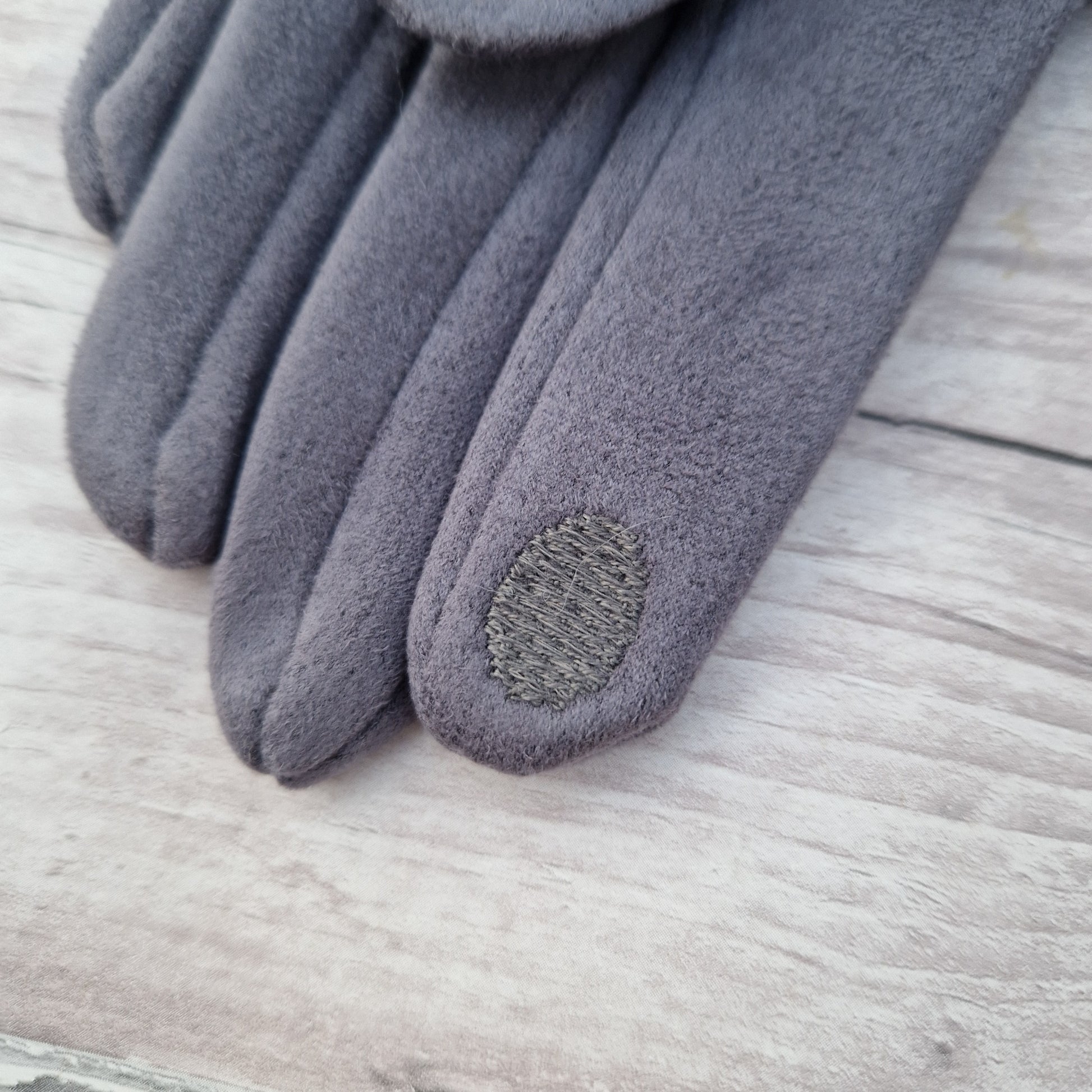 Textured finger pad on glove tip.