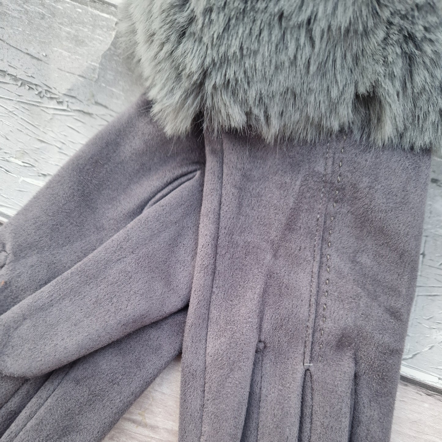 Silver Grey coloured gloves with a faux fur trim and stitching detail down the back of the hand.