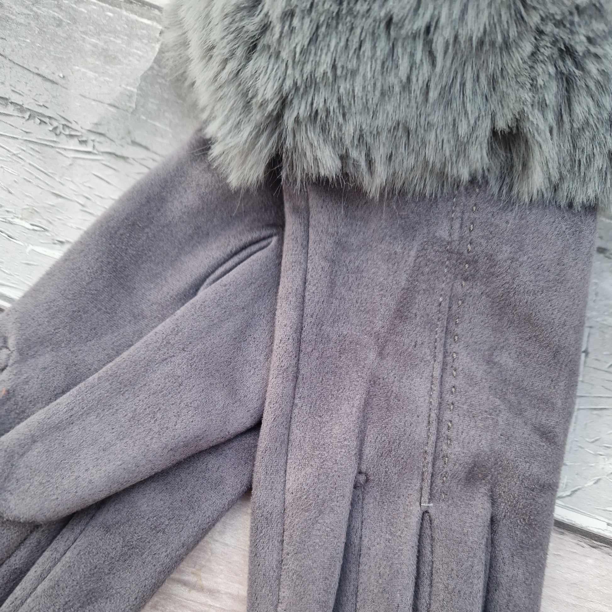 Silver Grey coloured gloves with a faux fur trim and stitching detail down the back of the hand.