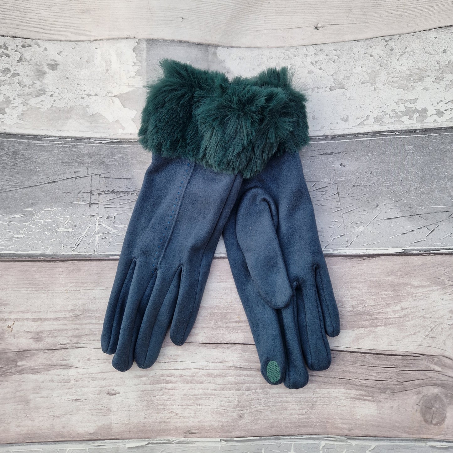 Teal coloured gloves with a faux fur trim and stitching detail down the back of the hand.