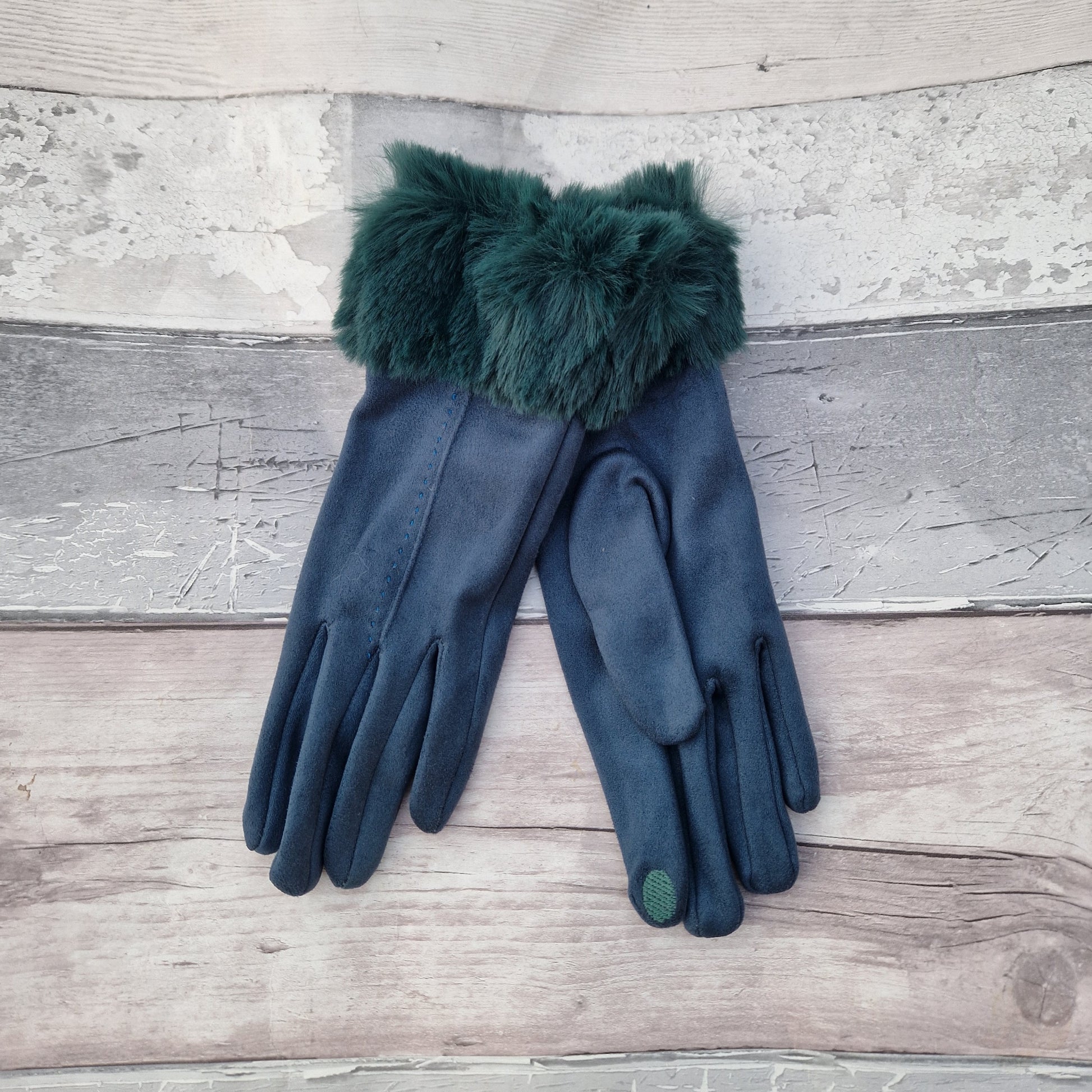 Teal coloured gloves with a faux fur trim and stitching detail down the back of the hand.