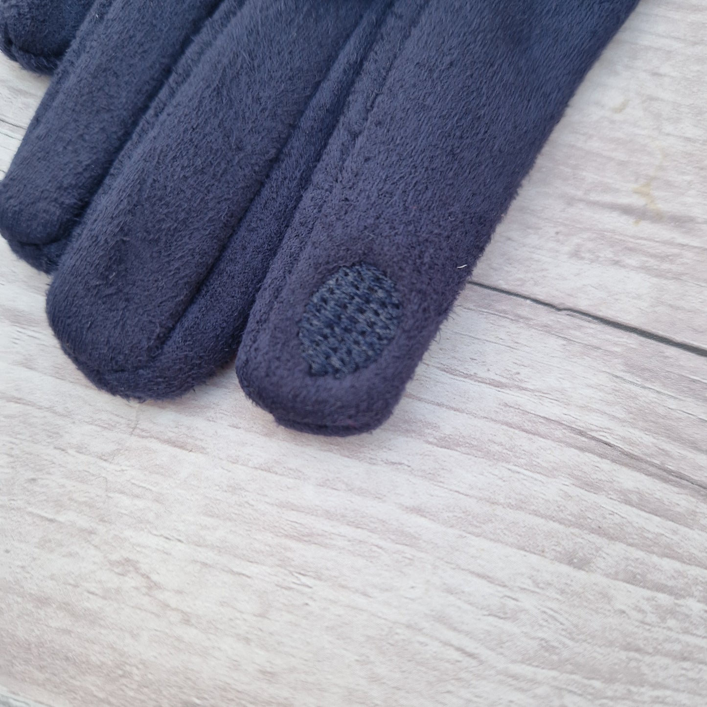 Texture d pad on finger end of glove.