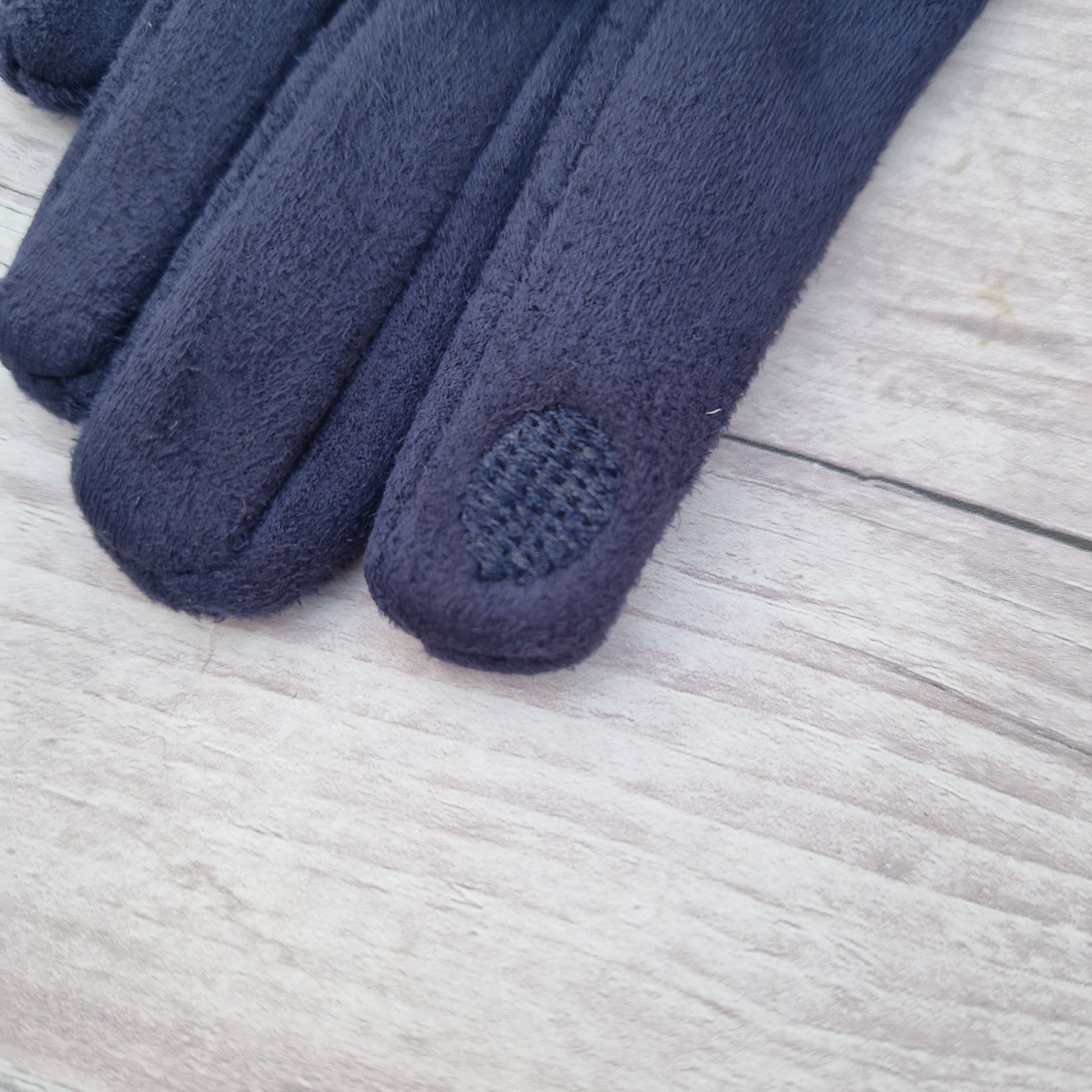 Texture d pad on finger end of glove.