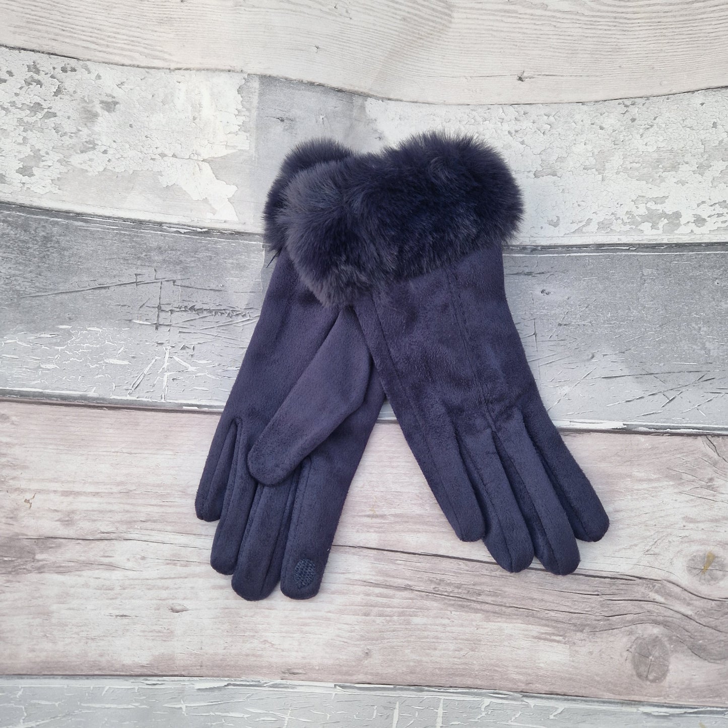 Navy coloured gloves with a faux fur trim and stitching detail down the back of the hand.