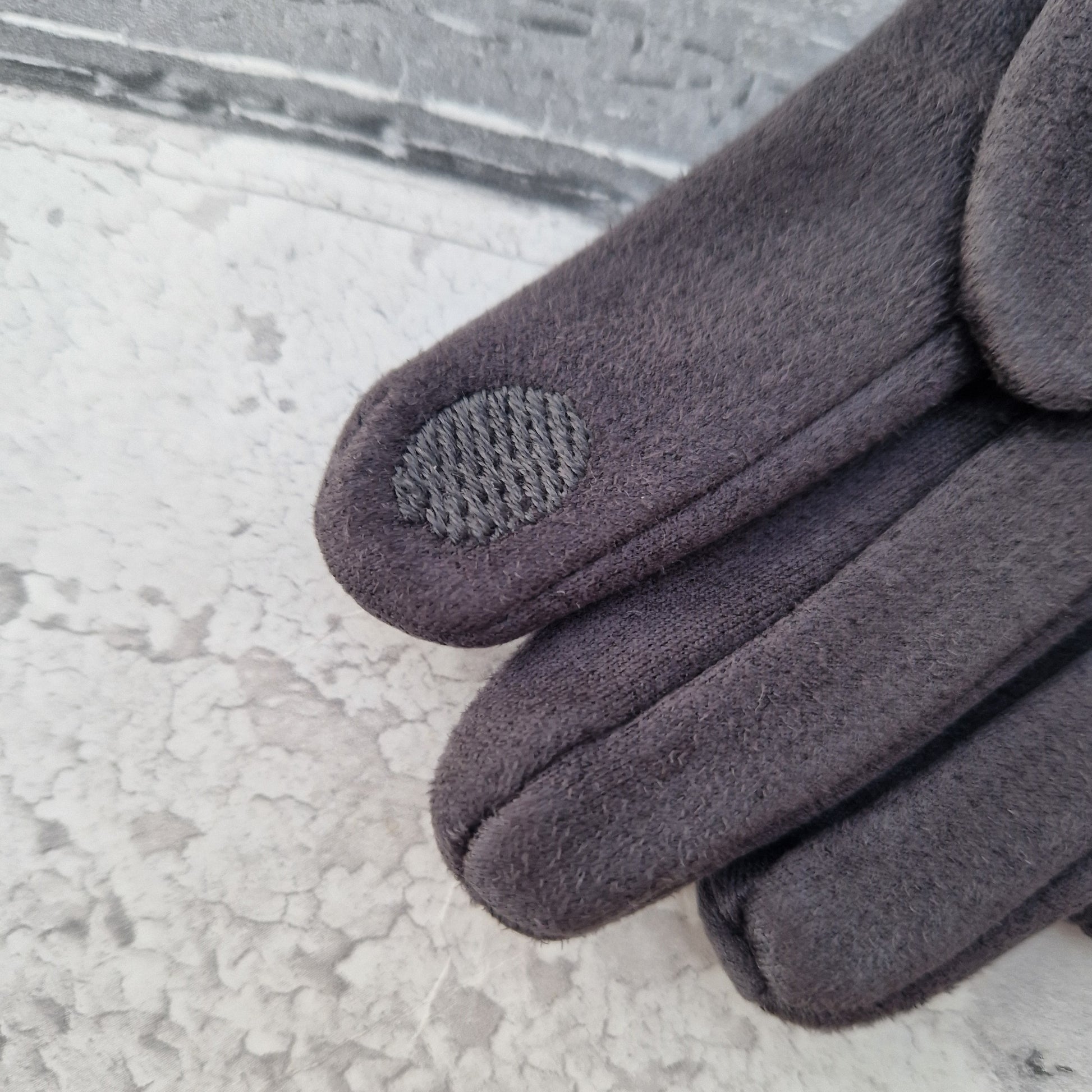 Textured pad on glove finger tip.