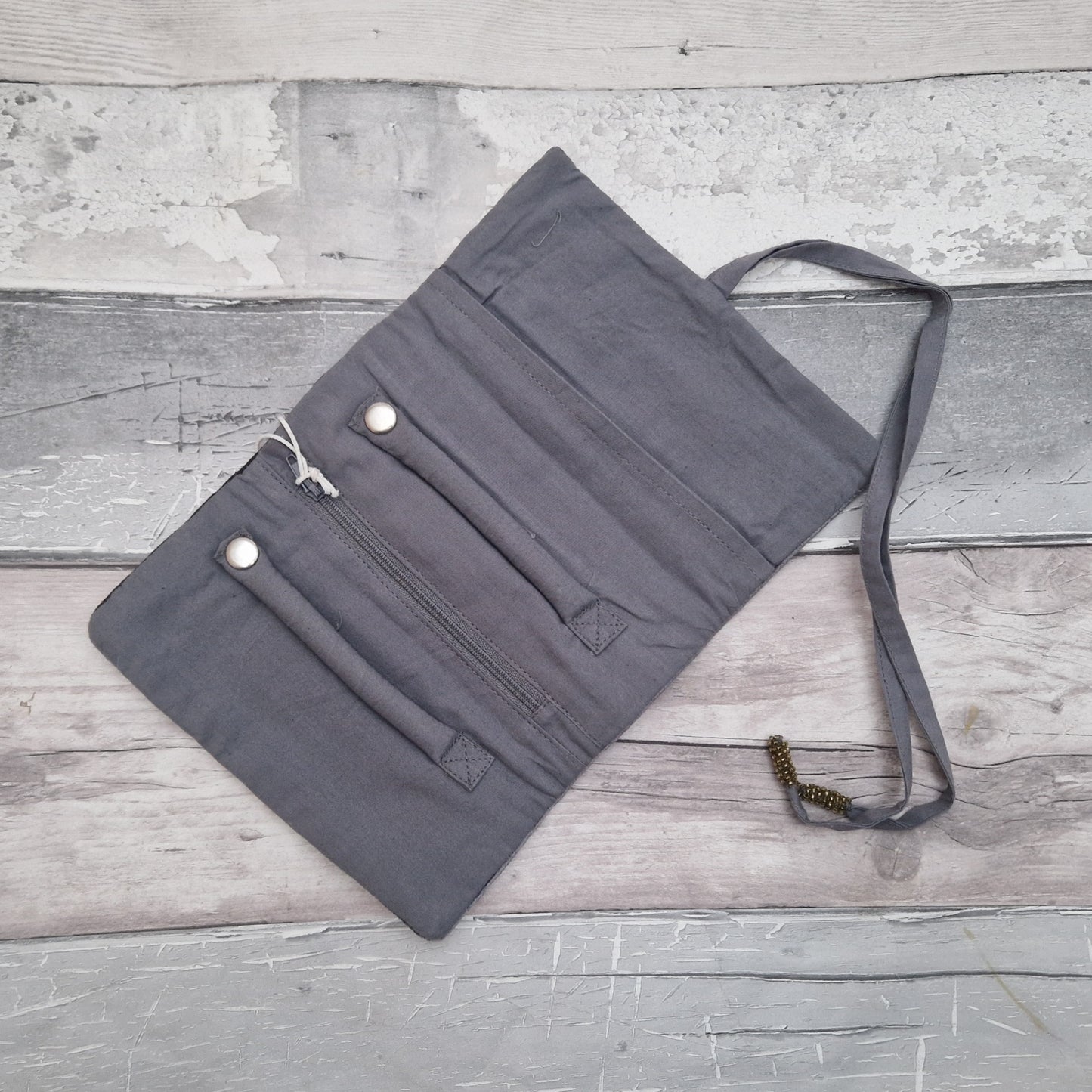 Inside view of a grey coloured jewellery roll.