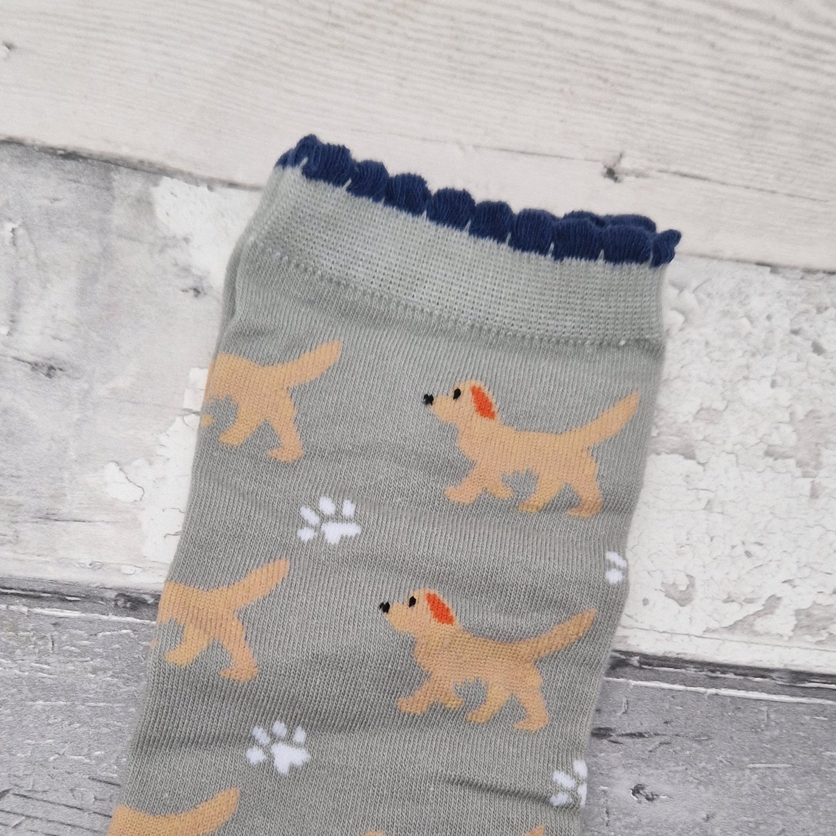 Gray sock with dog pattern on a wooden surface