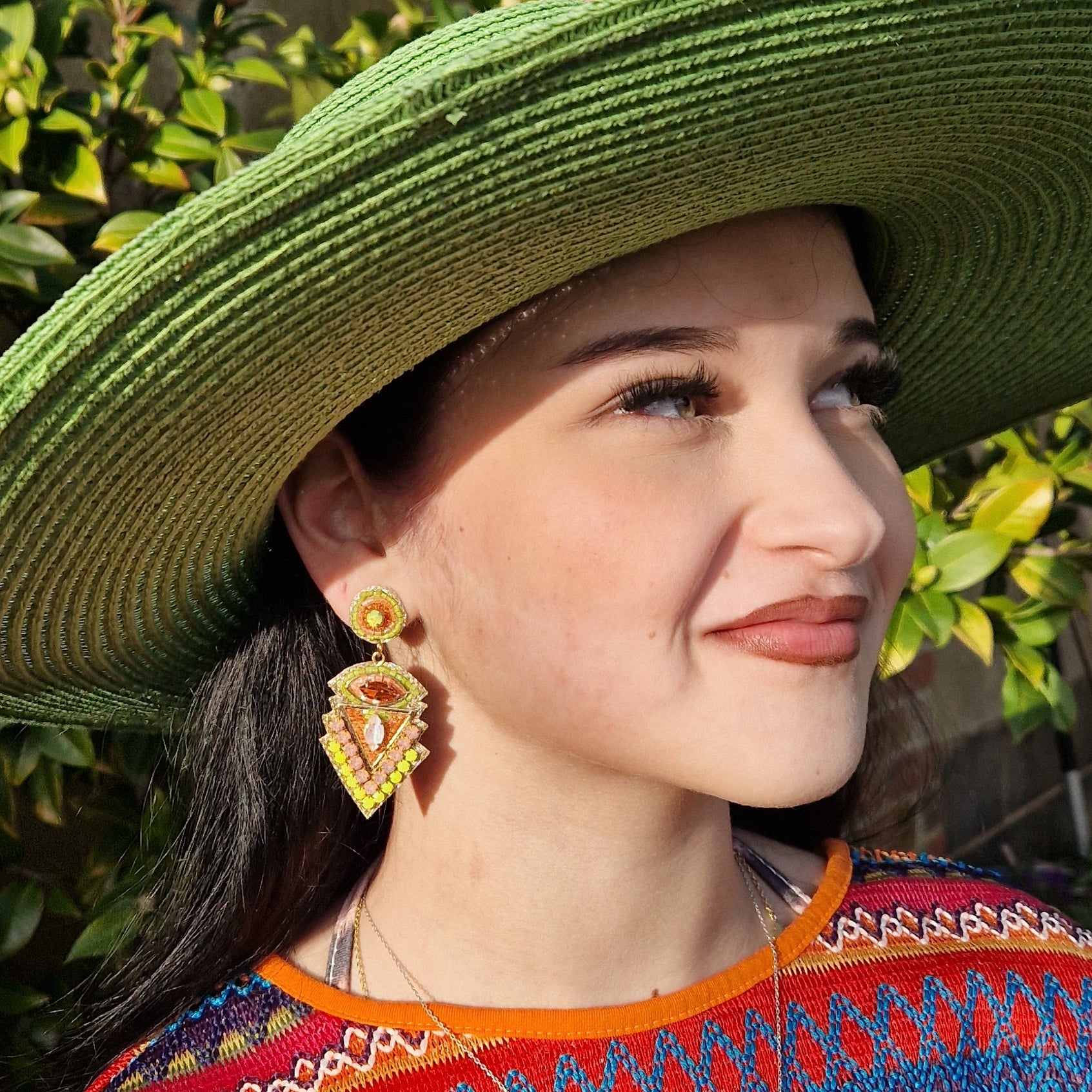Wide brimmed emerald green hat with matching belted band.