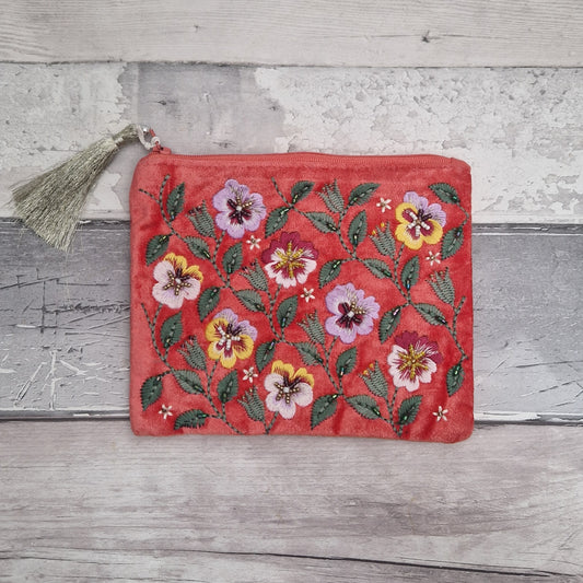 Deep salmon pink coloured velvet pouch decorated with embroidered purple and yellow pansies. Finished with hand sewn beads.