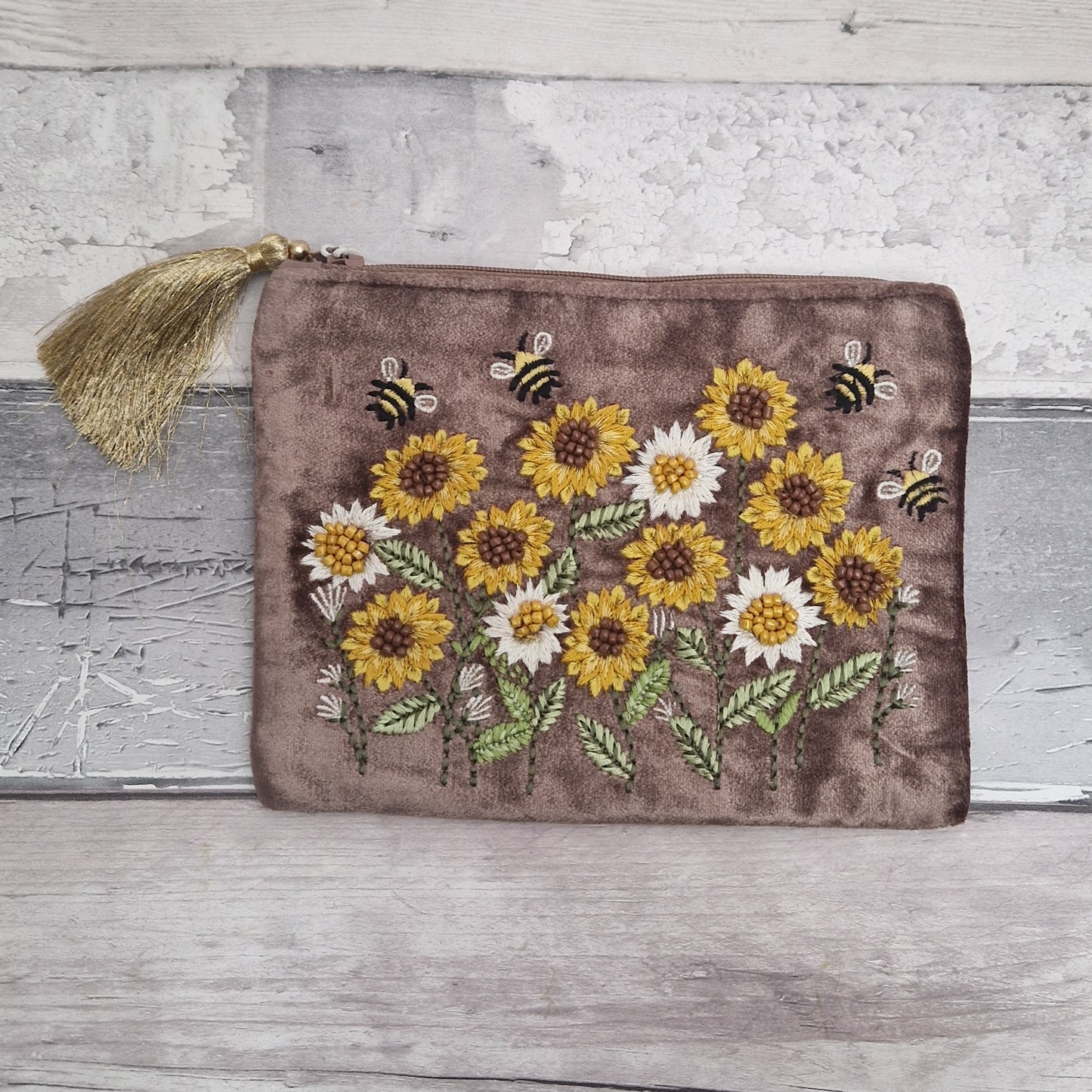Brown velvet pouch decorated with embroidered sunflowers and dancing bees. Finished with hand sewn beading.