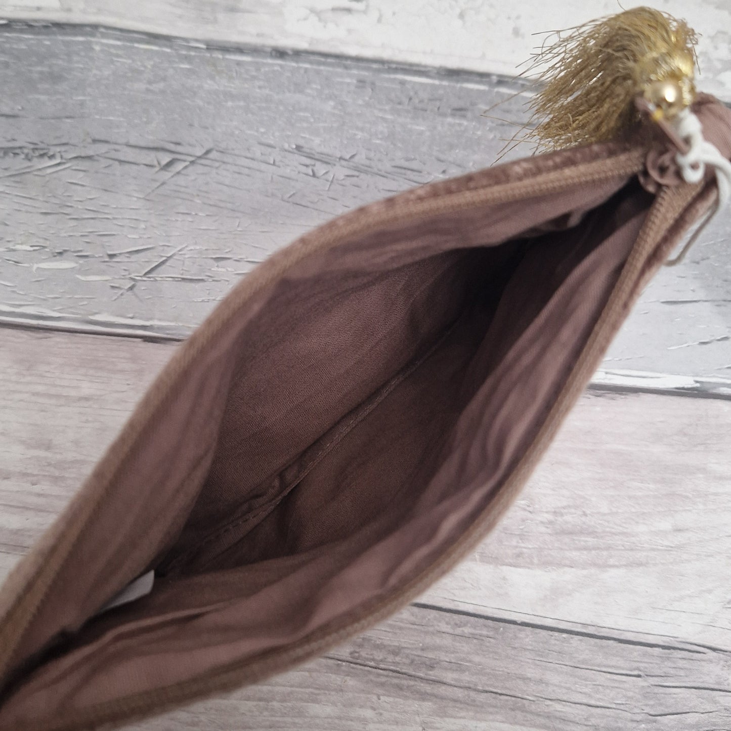 Inside view of brown velvet pouch.