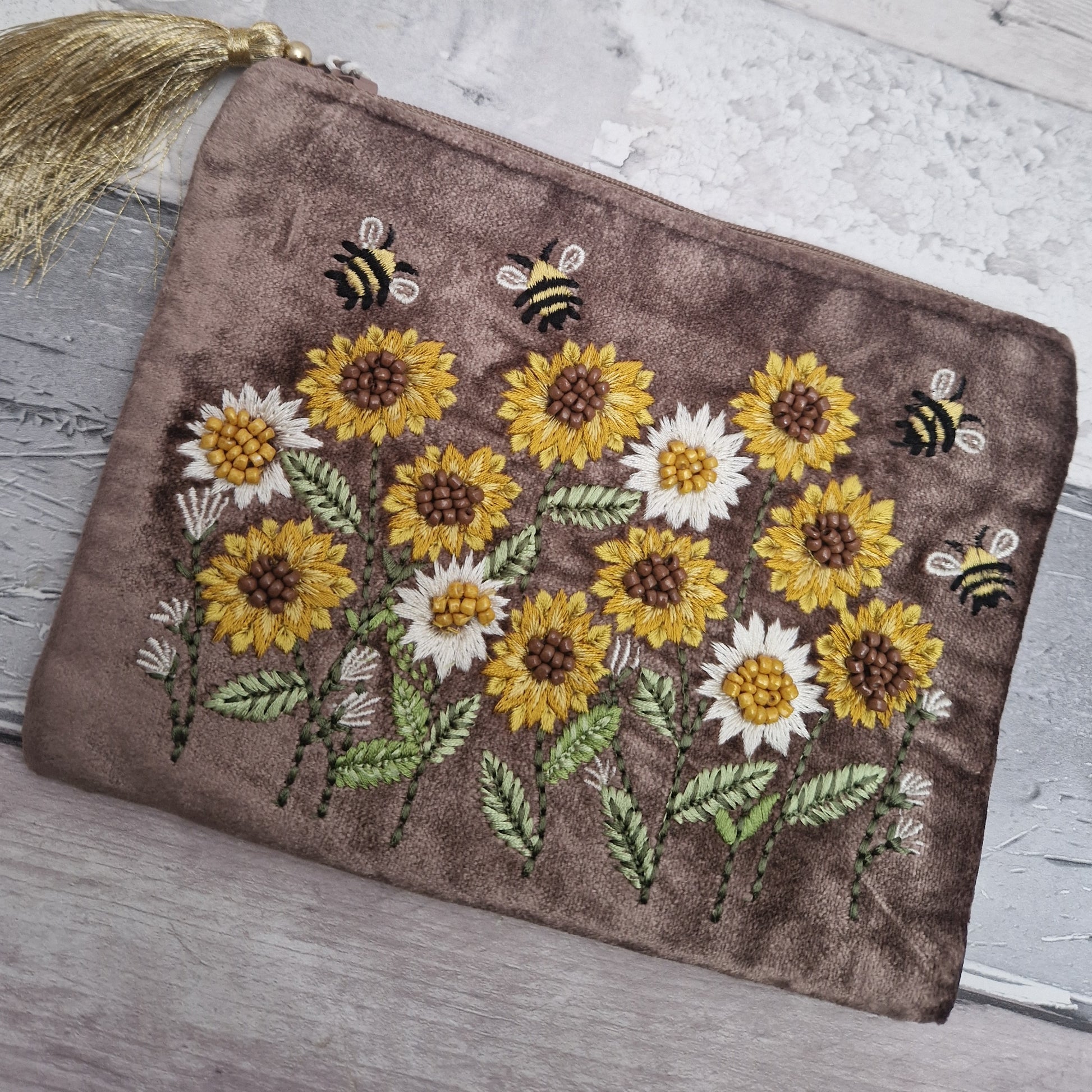 Brown velvet pouch decorated with embroidered sunflowers and dancing bees. Finished with hand sewn beading.