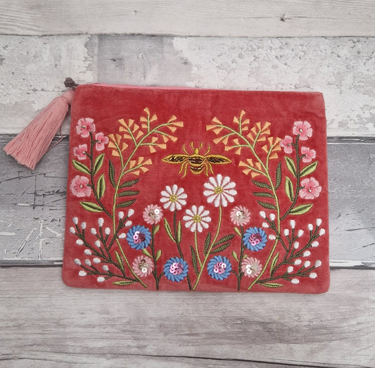 Coral pink velvet pouch decorated with embroidered flowers and a golden bee. Finished with hand sewn beading.